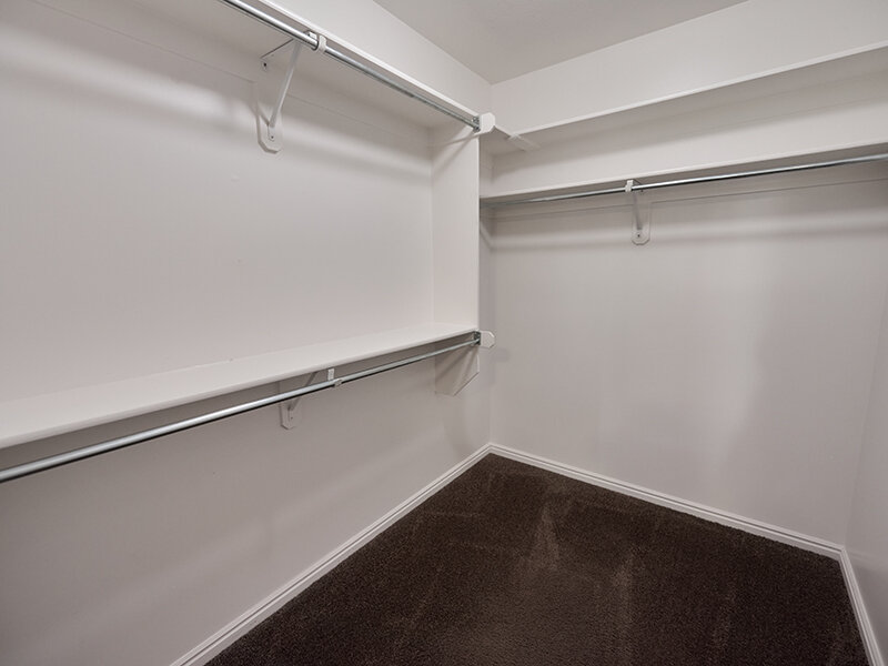 Open Closet with Rails and Carpeted Flooring | Autumn Hills Apartments
