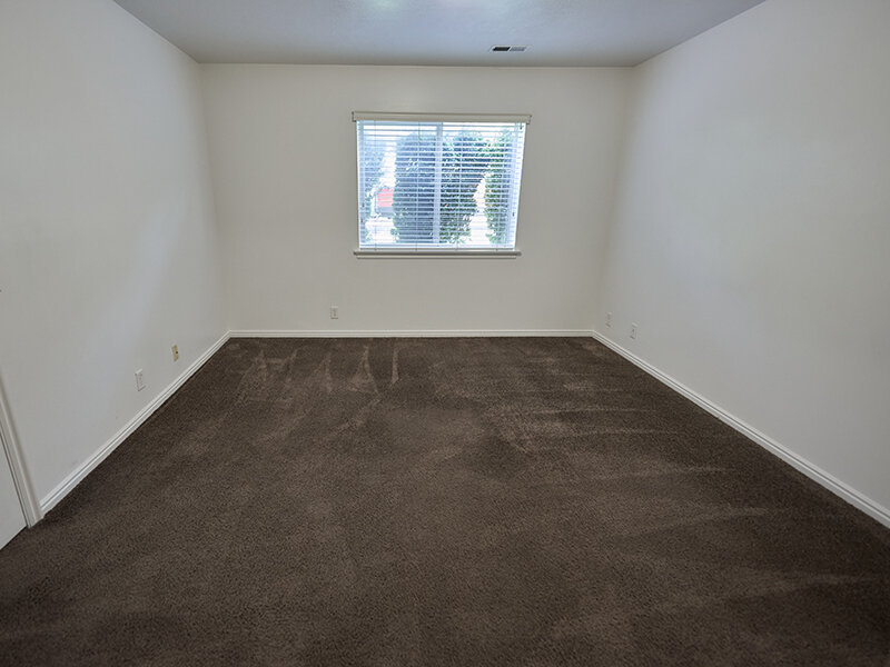 Apartment Bedroom with Carpeted Flooring and Window Autumn Hills Apartments