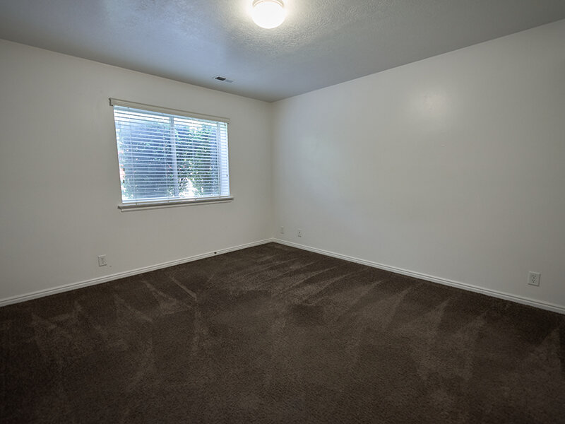 Bedroom with Carpeted Flooring and Window with Ceiling Light | Autumn Hills Apartments