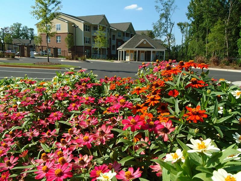 Landscaped flower beds surround the apartments at Colton Creek.