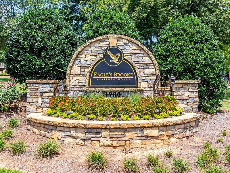 The landscaped welcome sign at the entrance of Eagle's Brooke Apartments in Locust Grove.
