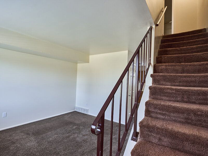 Living Room and Staircase with Rail and Carpeted Flooring | Kaysville Country Townhomes