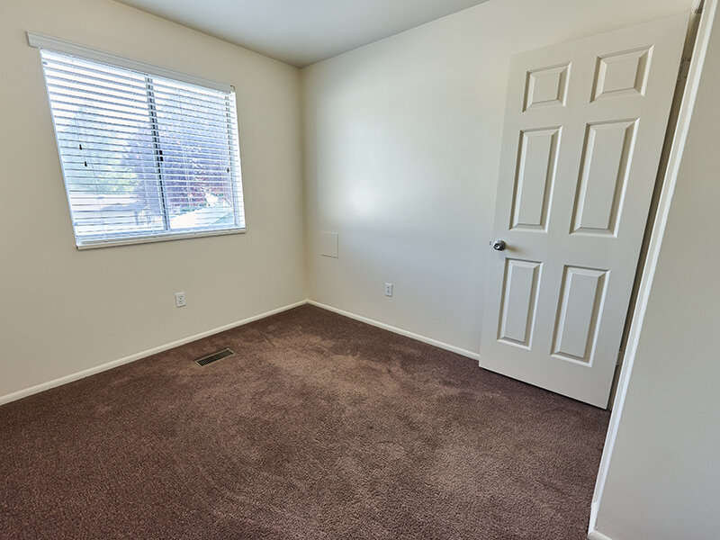 Open Bedroom with Window and Carpet Floors | Kaysville Country Townhomes