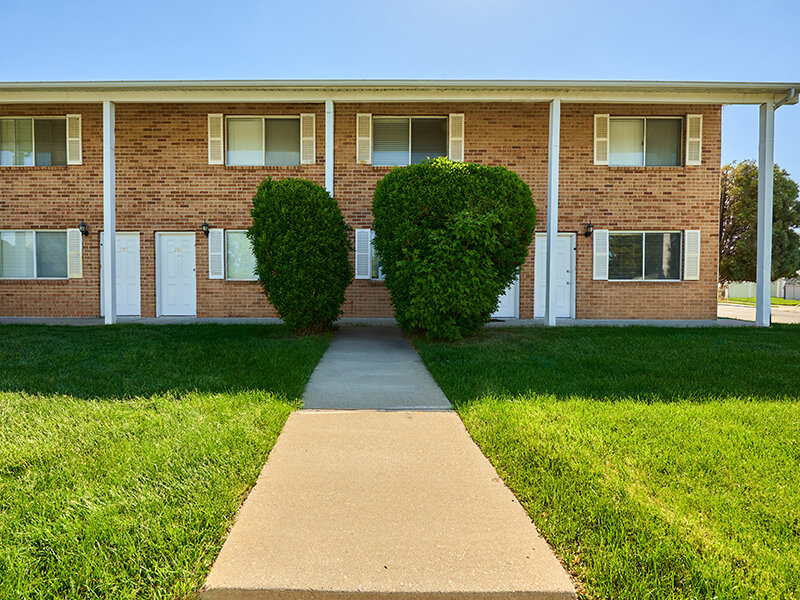 Exterior View of Apartment Property with Foliage and Sidewalk | Kaysville Country Townhomes