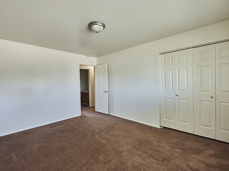 Apartment Bedroom with Ceiling Light and Closet | Kaysville Country Townhomes