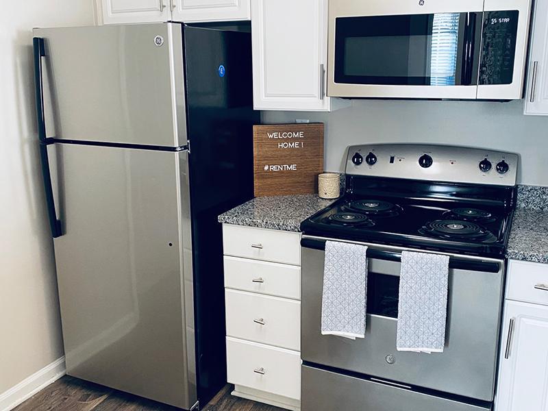 Stainless steel refrigerator and stove in the kitchen at The Lakes at Town Center Apartments.