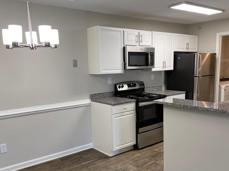 A dining area is attached to the kitchen at The Lakes at Town Center Apartments in Hampton.