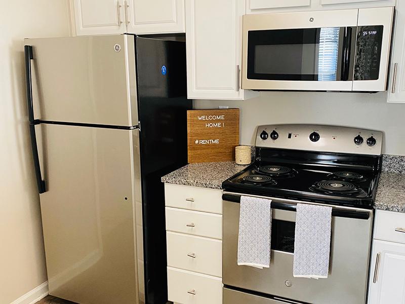Kitchen with a stainless steel refrigerator and stove at The Lakes at Town Center Apartments in Hampton.