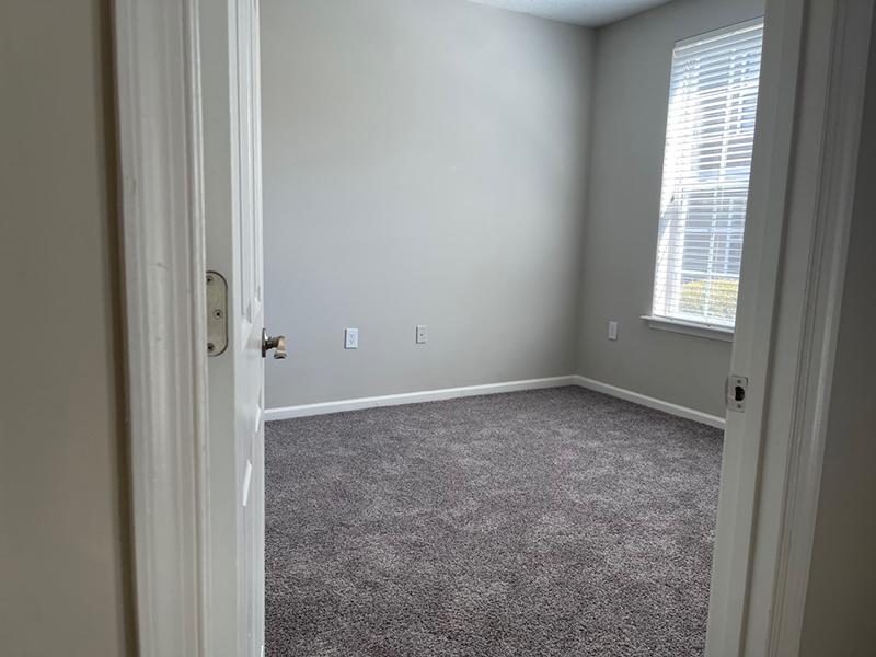 The doorway of a carpeted bedroom at The Lakes at Town Center Apartments in Hampton.