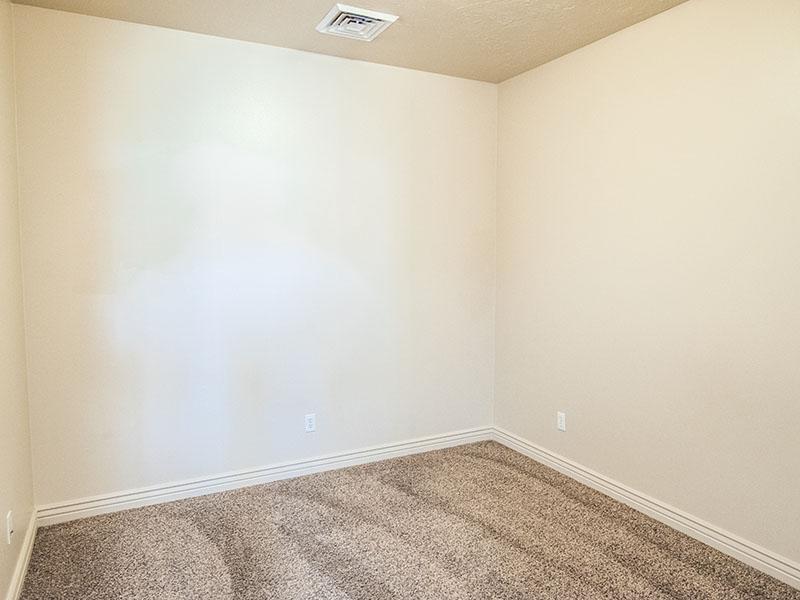 Carpeted Bedroom | Liberty Square Apartments in Ammon, ID
