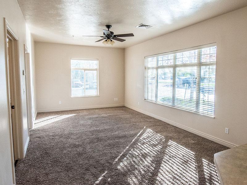 Living Room with Ceiling Fan | Liberty Square Apartments in Ammon, ID
