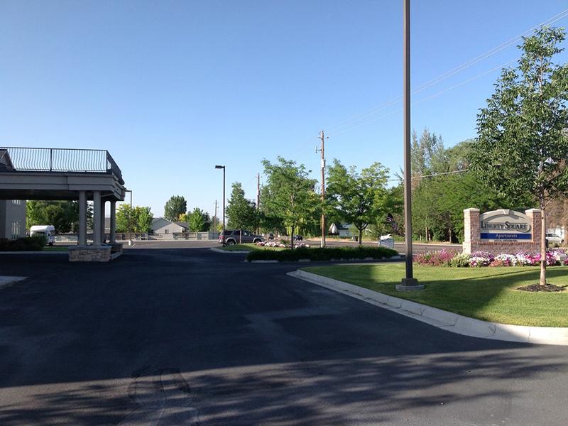 Welcome Sign and Parking Lot | Liberty Square Apartments in Ammon, ID