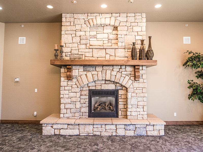 Fireplace with Seating | Liberty Square Apartments in Ammon, ID