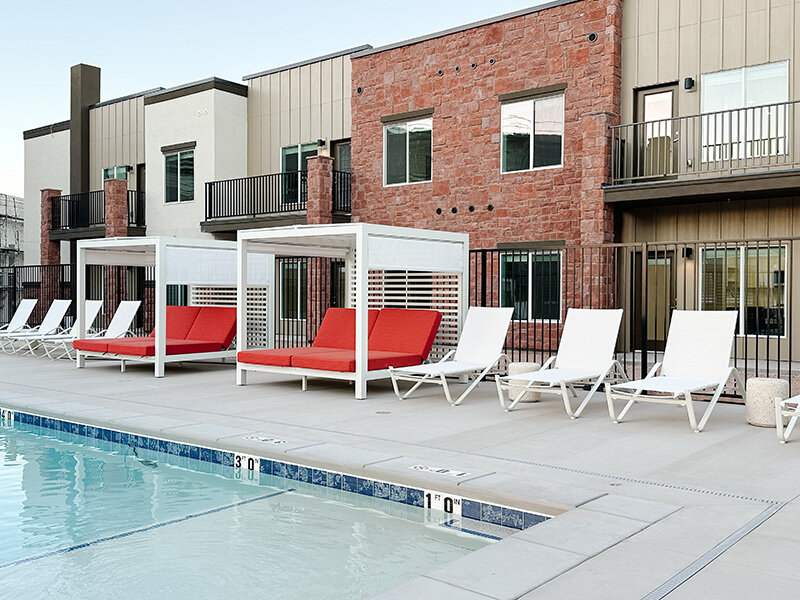 Outdoor Pool with Lounge Deck Seating | Millcreek Residences