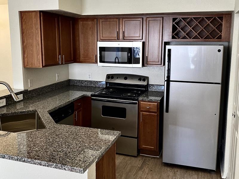 Model kitchen has stainless steel appliances at Providence Lakes apartments in Brandon, FL
