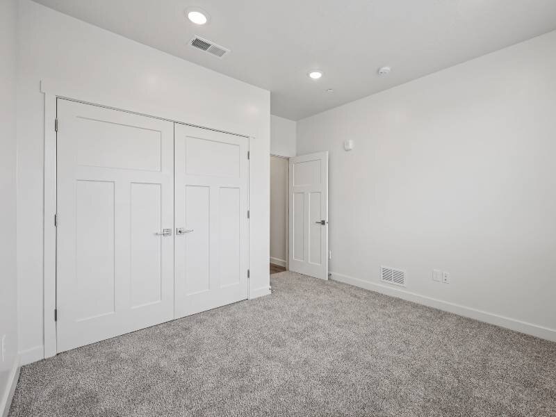 Carpeted Bedroom with Recessed Lighting | River Meadows Apartments