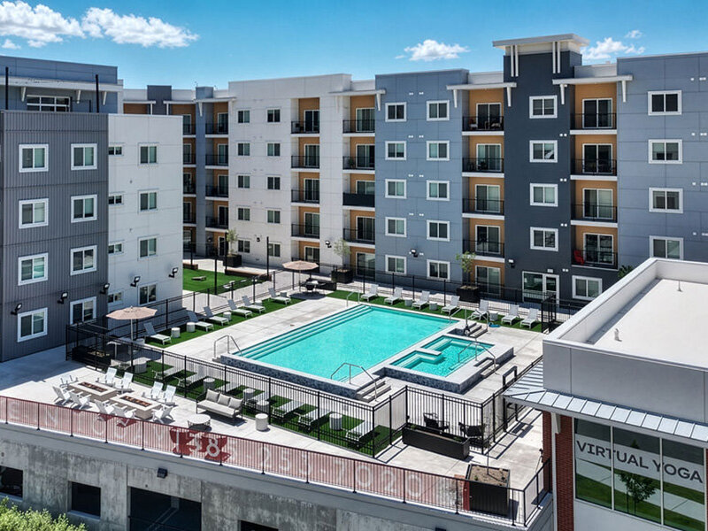 Swimming Pool and Building Exterior | Skyline Peaks Apartments
