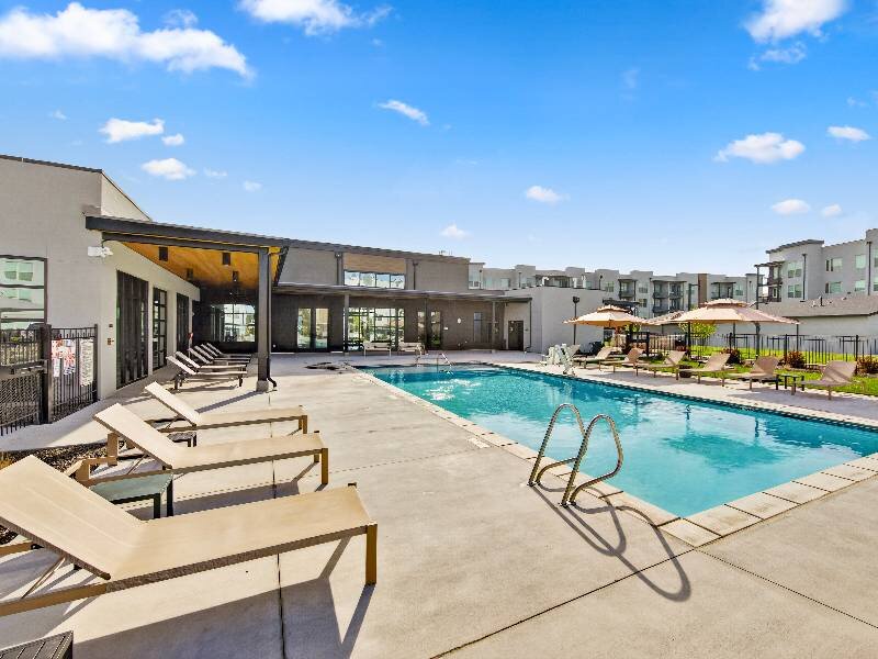 Pool with Poolside Furniture | Village Apartments
