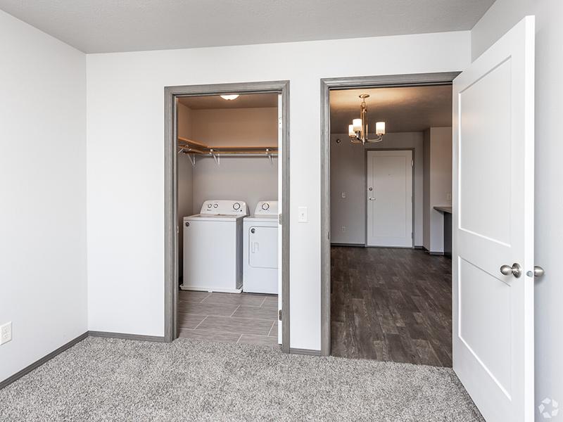 Bedroom and Washer & Dryer | Whisper Ridge Apartments in Sioux Falls, SD